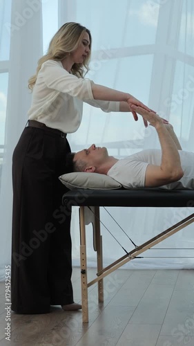 Spiritual practitioner speaking in bright studio while explaining healing concepts and mindful practices