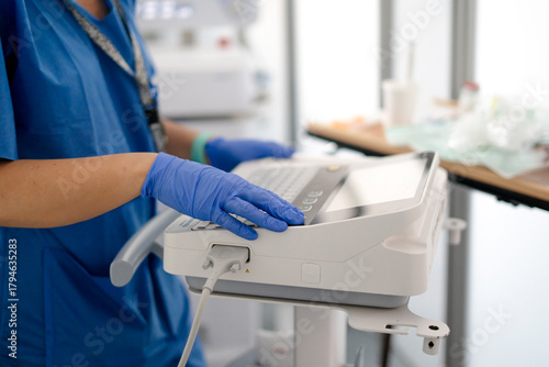 Medical professional using ultrasound machine in hospital environment
