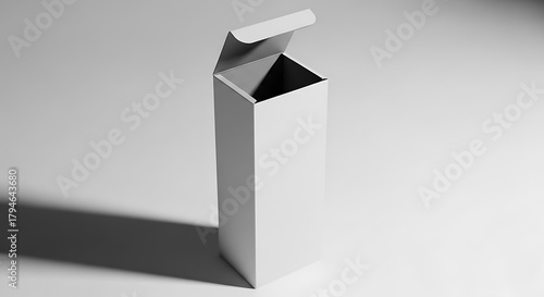 White cardboard box with open lid casting shadow on light gray background paper packaging