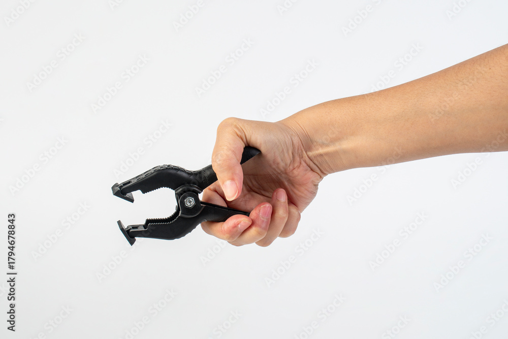 Fototapeta premium A studio shot of a black plastic spring clamp in hand isolated on a white background