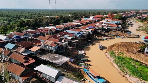Wallpaper Mural Aerial view of the stilt houses of kampong phluk floating village along the muddy river banks near tonle sap lake. Torontodigital.ca