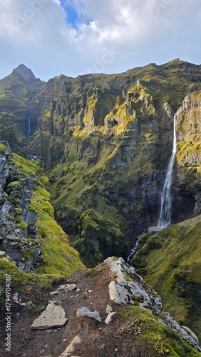 A breathtaking view of Múlagljúfur Canyon with Hangandifoss waterfall cascading down moss-covered cliffs in southern Iceland. A hidden gem offering dramatic landscapes and peaceful solitude.