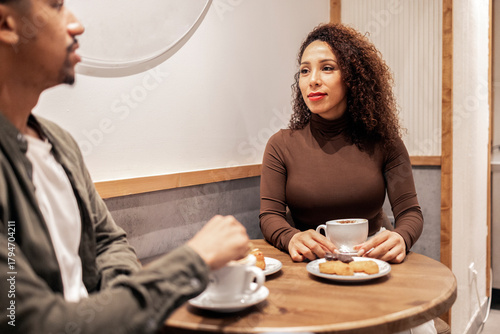 Hispanic couple having coffee in a cafe.