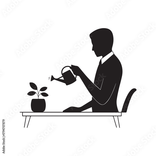 Silhouette of a man watering a plant on a desk