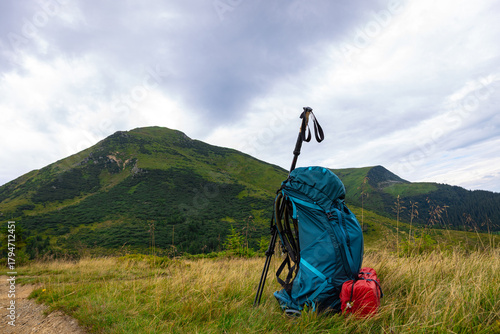 Summer hiking in the mountains with a backpack and a tent. Beautiful mountain landscape.