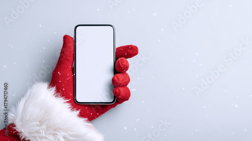 Santa Claus hand holding smartphone, Christmas technology concept, digital holiday greeting