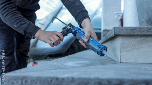 Photos Applying sealant to a countertop during a home renovation project