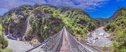 Suspension bridge in Taroko Gorge Taiwan with waterfall and river