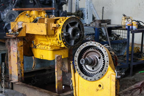 Heavy-duty allison transmission assembly and final drive unit disassembled for maintenance in a professional industrial workshop setting.