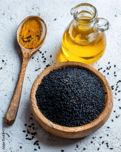 Black Sesame Seeds In Wooden Bowl With Oil