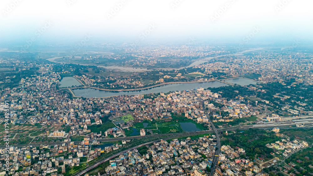 Obraz premium Top down Buildings and Apartment with Multiple Building aerial. Urban Buildings and Apartment at bridge road at Delhi. Cinematic cityscape drone shot. Noida Buildings.