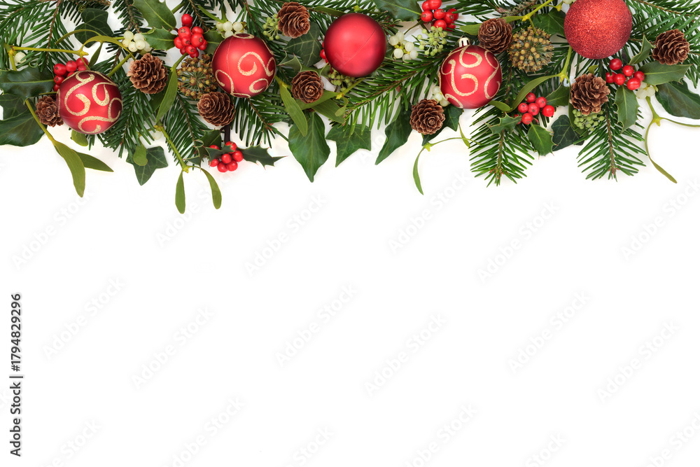 Fototapeta premium Xmas festive red gold bauble decorations, holly, mistletoe berries, ivy, fir, pine cones. Christmas winter nature flora border design on white background.