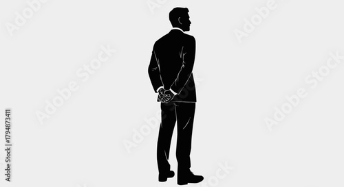 Silhouette of a businessman standing with hands clasped behind his back.