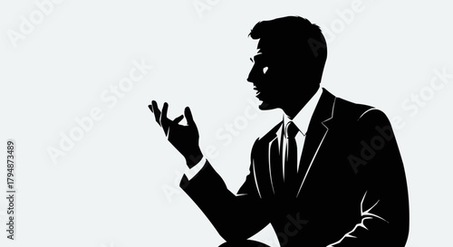 Silhouette of a businessman in a suit gesturing while speaking.