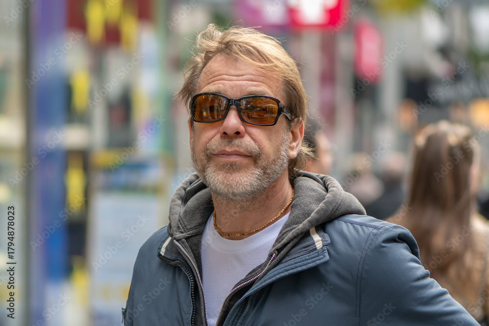 Fototapeta premium A fifty-year-old European man is on a busy street in the city center.