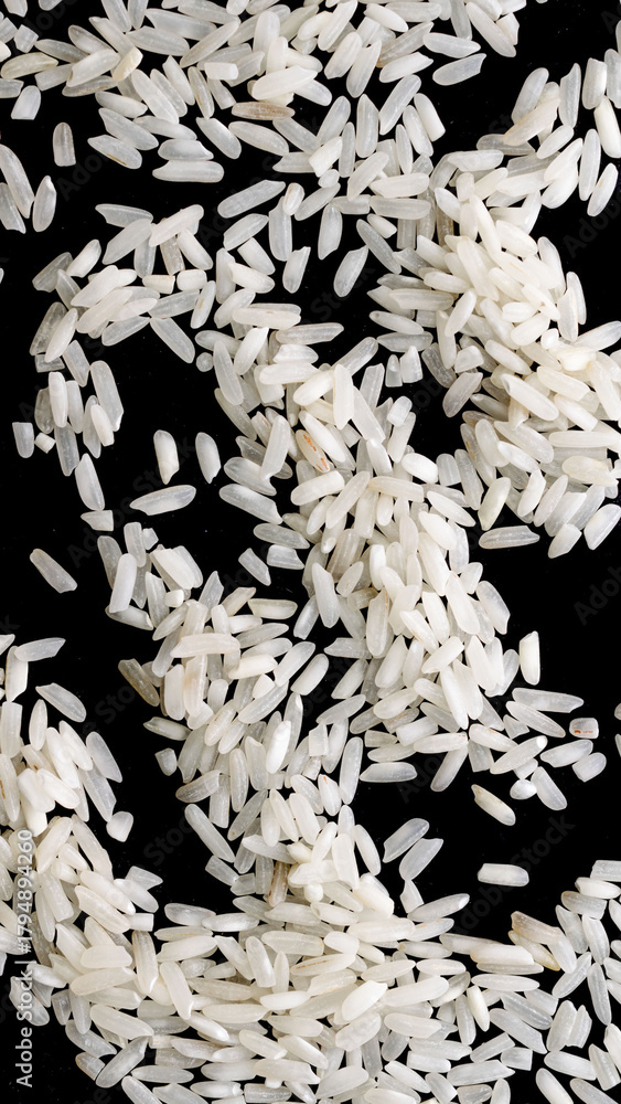 Fototapeta premium white rice on a black isolated background