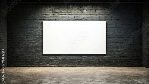 A blank white canvas hangs on a dark brick wall in a dimly lit room, ready for artwork