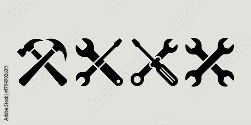 Crossed black silhouette icons of tools on a light background