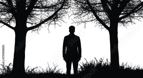 Silhouette of a man standing between two trees in black and white