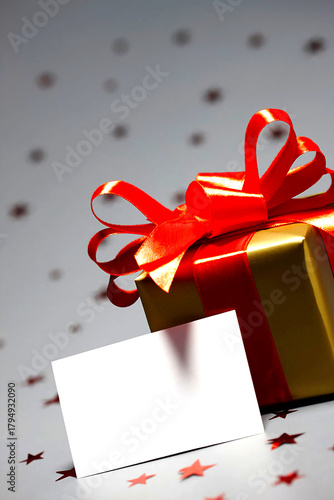 Golden Gift: A meticulously wrapped present, adorned with a vibrant red ribbon, sits beside a blank card, ready to convey a heartfelt message of celebration and appreciation.