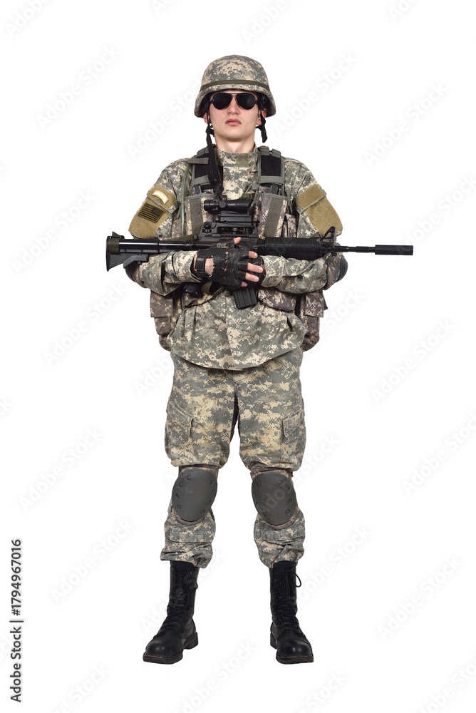 Obraz premium Man stands at full height in an American soldier's uniform holds a rifle