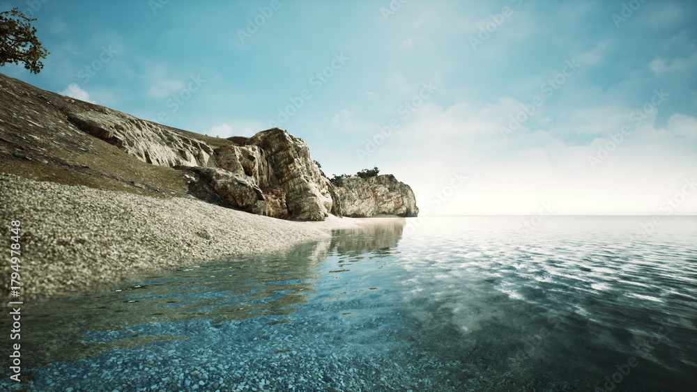 Fototapeta premium Gentle waves lap against a sandy beach as sunlight dances on the waters surface. A rocky cliff rises on one side, with trees dotting the landscape, creating a serene coastal view.