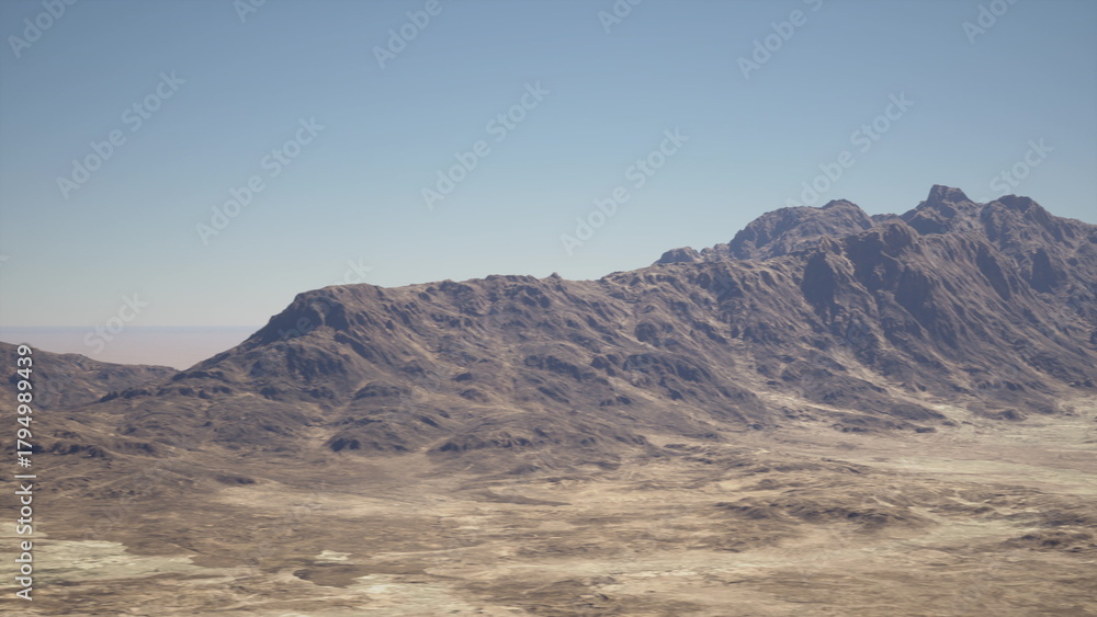 Fototapeta premium A vast desert stretches across the foreground, highlighting rugged mountains in the distance. The scene captures a warm, clear day with no clouds in sight, evoking a sense of serenity.