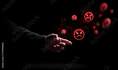 A pointing finger emanating angry emoji on a dark background, concept of anger.