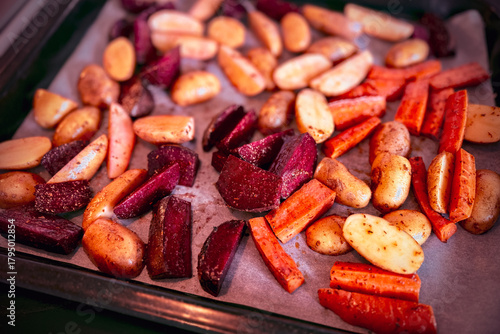 Freshly made homemade colorful healthy organic oven-roasted root vegetables including beets, carrots and potatoes