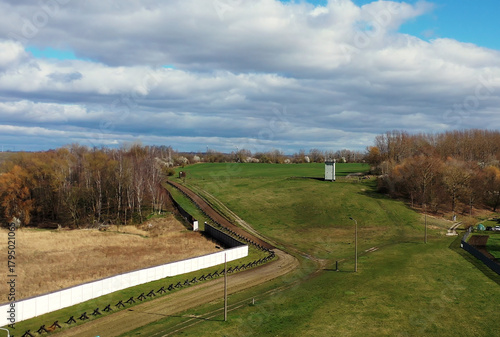 Berlin wall memorial featuring watchtower and border fortifications, representing cold war division and german history