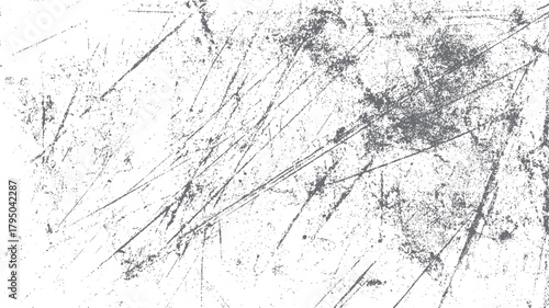 Abstract textured background with grey scratches and speckles on white surface grunge