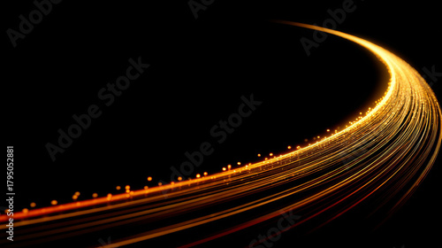 Dynamic curve of glowing golden light streaks on black background creates sense of motion and energy