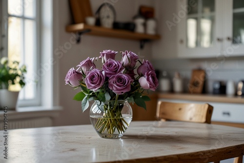 dark purple roses in a vase against a kitchen background