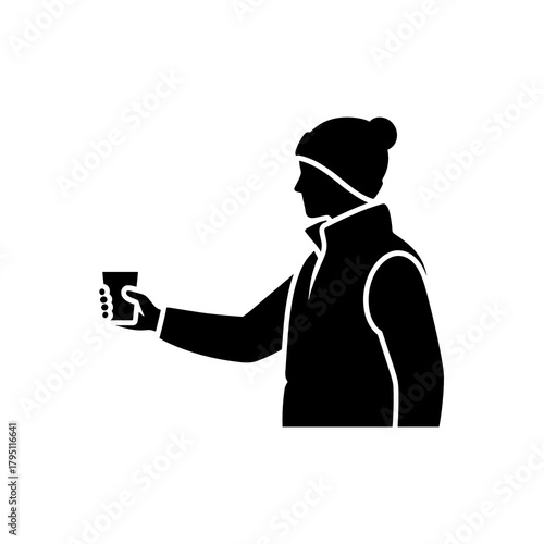 Volunteer in a winter vest handing out a water cup during the Winter Marathon Race  