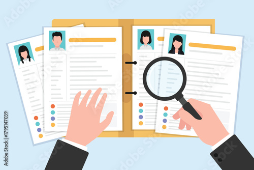 Hand holding a magnifying glass examining multiple resume or CV documents.