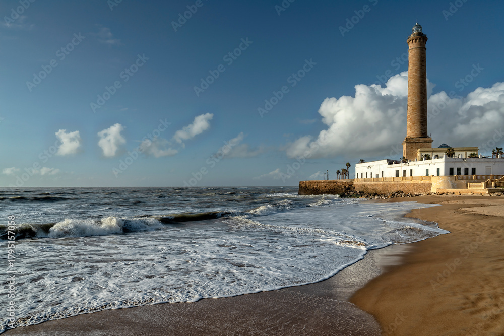 Obraz premium Chipiona, Spain. Chipiona Lighthouse on the Ocean Shore. Sea travel and tourism, Atlantic 