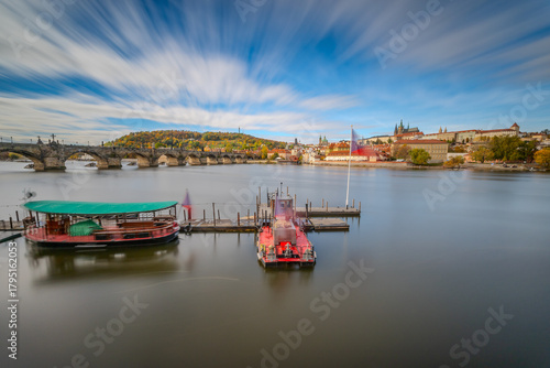 Autumn Panorama of Prague Castle Above the Vltava River with Historic Bridges and the Cityscape of Prague, Czech Republic, Captured in Warm Fall Colors During a Calm Scenic Evening