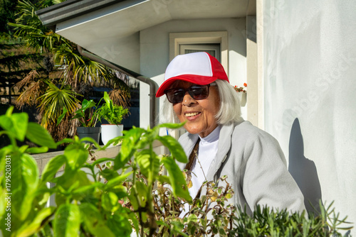 Smiling senior woman gardening outdoors on a sunny day