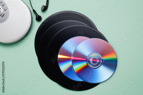 Collection of vintage retro vinyl records, CD disk, CD player and earphones. Retro acoustic. Saving data, music, movies, videos. Vintage media concept. Top view.