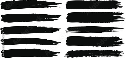 Black grunge paint brush stroke elements set on white backdrop