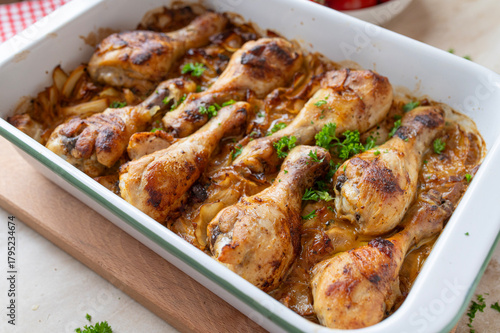 Oven baked chicken drumsticks with braised cabbage in a  casserole dish fresh and homemade cooked