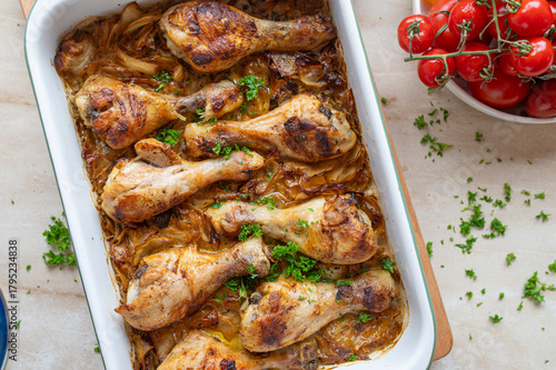 Oven baked chicken drumsticks with braised cabbage in a  casserole dish fresh and homemade cooked