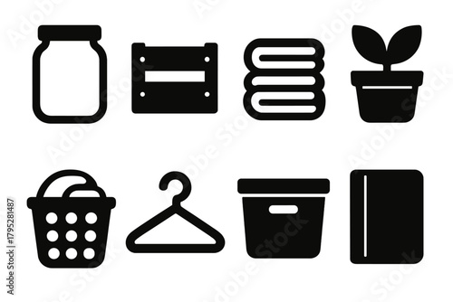Minimalist Home Storage Icons. Minimalist Home Storage silhouette icons set: glass jar, wooden crate, folded towels, plant pot, laundry basket, coat hanger, storage bin, notebook.