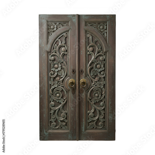 Ornate antique wooden double doors with intricate carved floral and swirling patterns and brass handles
