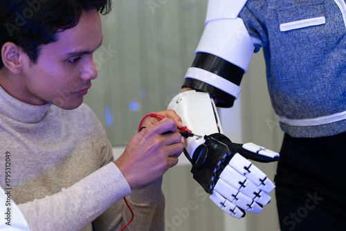 Engineer demonstrating advanced robotic prosthetic arm technology with colleague in research lab. Concept of innovation, artificial intelligence, robotics, human-machine collaboration, and healthcare.