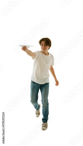 A teenage boy throwing a paper airplane