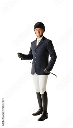 A male equestrian in full gear no horse looking proud holding a riding crop