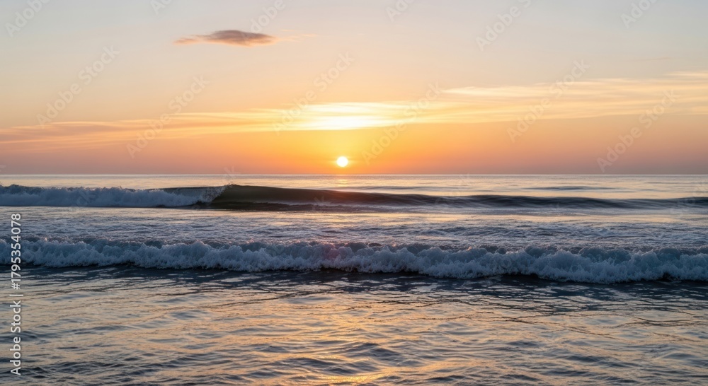 Fototapeta premium Golden Ocean Sunset with Gently Rolling Waves and Tranquil Sky