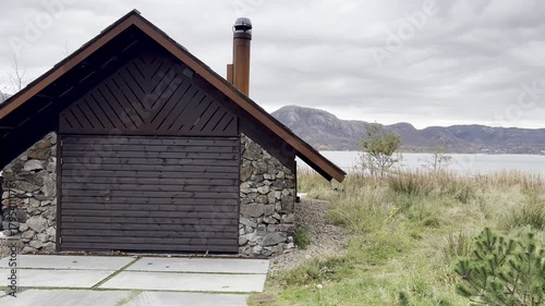 Stavanger, Norway - October 29, 2025: Traditional colorful wooden house in Norway. Wooden house in foggy Norwegian village. Norwegian houses with gable roofs. Scandinavian streets. Old-style houses.
