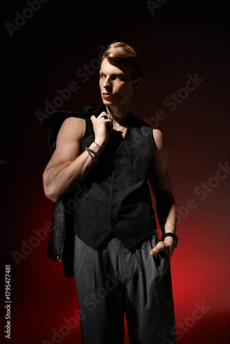 Young man embodies modern masculinity with allure and confidence in a stylish setting